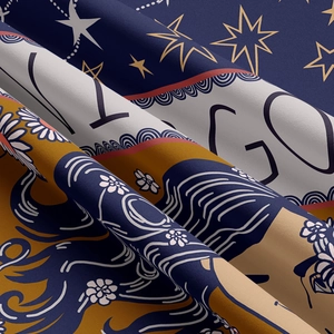 Macro detail of high-quality fabric showing intricate zodiac patterns and floral prints