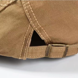 Detail of adjustable metal buckle and reinforced stitching on cotton linen beret hat