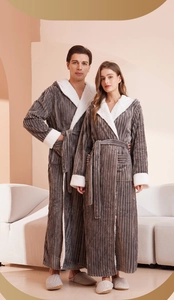 Detail of grey striped flannel bathrobe featuring soft white fleece lining and texture