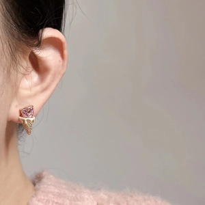 Close-up of heart ice cream stud earring with pink zircon and gold-tone finish