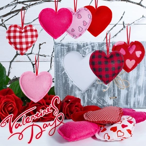 Detailed view of red and pink fabric heart ornaments for Valentine's Day decor