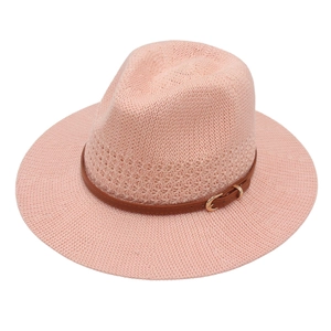 Pink knitted fedora with brown faux leather belt and gold buckle on a white background