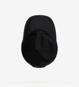 Internal view of a black flat top military cap showing cotton lining and sweatband details
