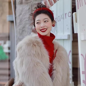 Fashionable woman wearing vintage round ball earrings with white faux fur coat and red knitwear