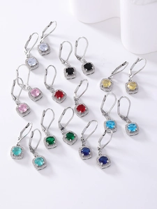 Macro shot of colorful square halo earrings set in silver with various zirconia stones