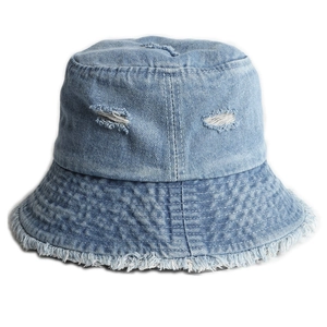 Light blue distressed denim bucket hat with ripped details and raw edges on white background