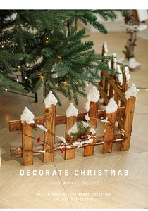 Close-up of wooden Christmas fence with artificial snow and red berries for holiday decor
