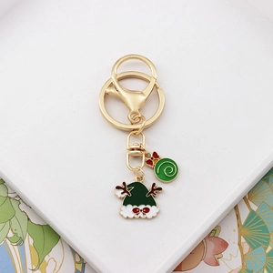 Detailed shot of Christmas keychain with green Santa hat and swirl candy charms