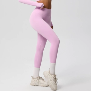 Side view of high-waist seamless pink yoga pants with matching long-sleeve athletic top