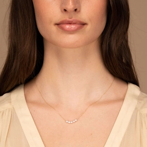 Detailed view of 18K gold plated necklace with five small natural freshwater pearls