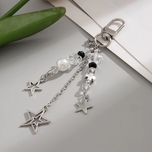 Close-up of star pendant keychain with pearls, crystals, and beads on silver chains