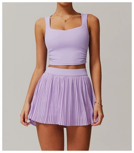 Detail of lavender sports set featuring square neck tank top and pleated fitness skirt