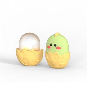 Macro shot of a cute chicken-themed silicone night light with glowing egg effect and soft texture