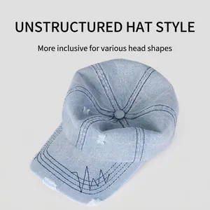 Distressed light blue denim baseball cap with frayed edges and decorative stitching