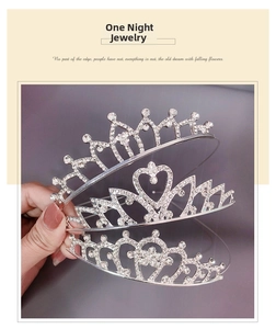 Detailed view of silver sparkling rhinestone tiaras with intricate heart and floral patterns
