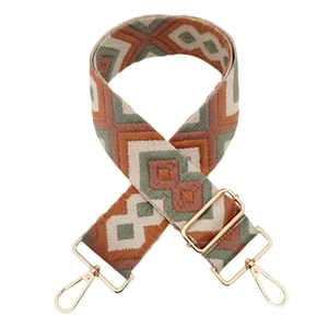 Detail of 5cm wide bohemian geometric jacquard bag strap with gold metal hardware