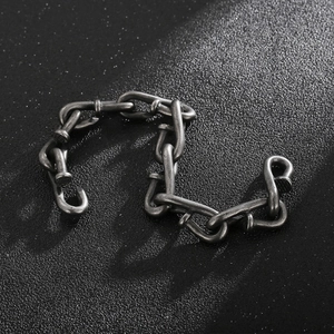 Detailed view of interconnected nail-shaped chain links in vintage oxidized steel