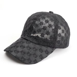 Detail of floral lace embroidery and breathable mesh texture on a black baseball cap