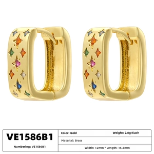 Detail view of gold brass earrings with colorful star gems, 12mm width and 15.5mm length