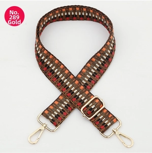 Detail of adjustable geometric woven strap with ethnic patterns and gold metal hooks