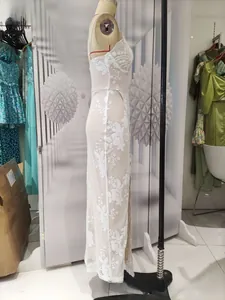 Detail view of white lace floral embroidery on side slit sequin evening dress