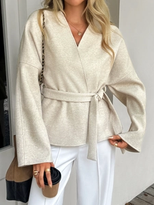 Detailed view of beige V-neck tie-waist cardigan with loose drop shoulder and matching belt