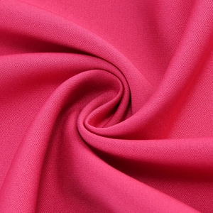 Close-up of rose red twill fabric texture showing premium weave and draping material