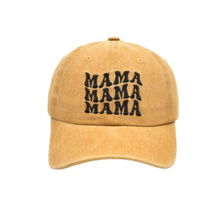 Close-up of the vintage mustard cotton baseball cap featuring black MAMA embroidery