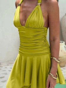 Detail of lime green halter dress featuring a metal ring buckle and pleated waist design