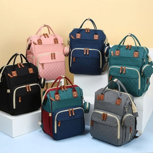 Collection of large capacity diaper backpacks in six vibrant colors for travel and baby care
