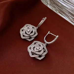 Exquisite silver-tone hollow rose earrings featuring intricate zircon micro-paving details