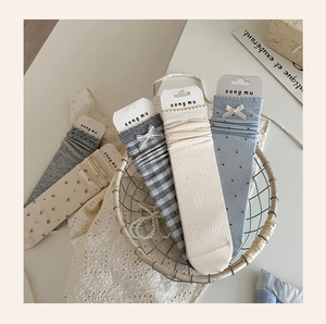 Close-up of cute blue bow socks with lace trim and diverse patterns for girls