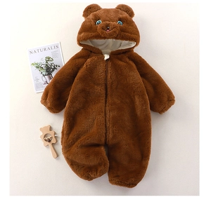 Detailed macro view of the brown plush bear-themed baby romper with animal hood
