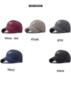 Color display of washed cotton baseball caps with minimalist heart embroidery details