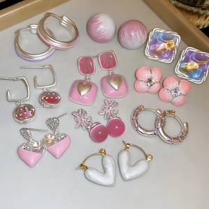 Detailed set of floral and heart-shaped earrings with cat eye stones and pink enamel finish