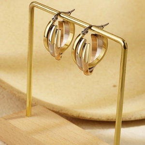 Three-tone stainless steel hoop earrings in gold silver and rose gold intertwined design