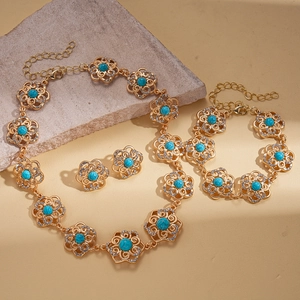 Vintage gold hollow flower jewelry set with turquoise stones and shimmering rhinestones