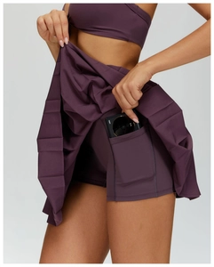 Detail of tennis skirt side pocket holding a smartphone with inner liner design