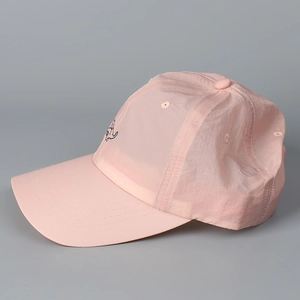 Close-up of the light pink quick-dry baseball cap featuring detailed side embroidery