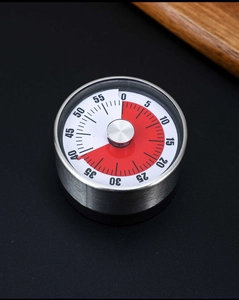 Macro shot of mechanical visual timer dial showing 40-minute remaining red zone