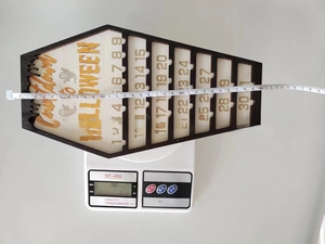 Detailed view of wooden coffin Halloween countdown calendar showing 30cm length and weight.
