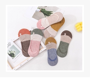 Close-up of pastel cotton boat socks with cute rabbit embroidery and patchwork colors