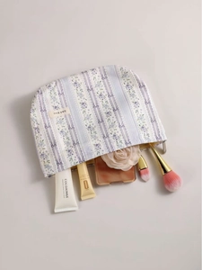 Floral print purple vanity bag with zipper closure and spacious storage for toiletries