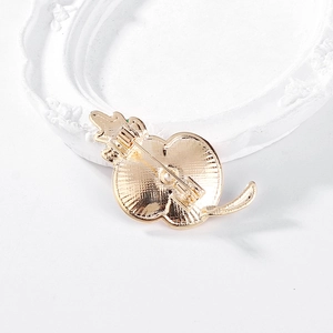 Golden poppy brooch back view with metal pin detail against an elegant white frame