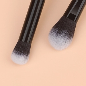Close-up of two-tone gradient fiber bristles on professional makeup brushes with black handles