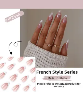 Macro detail of French tip press-on nails with white floral patterns and subtle glitter