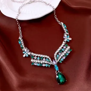 Vintage floral necklace set with emerald pear-shaped crystal pendant on red silk