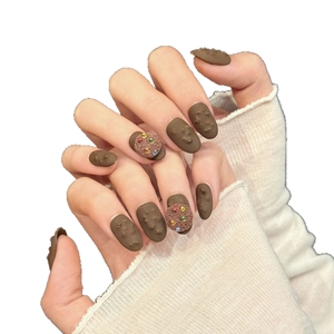 3D chocolate cookie press-on nails in matte brown almond shape with colorful accents