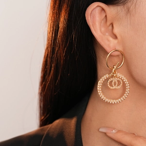 Elegant gold double hoop earrings with white pearls and knot charm for women
