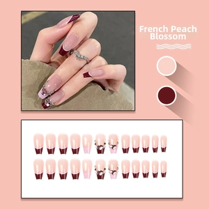Detailed set of 24 French style press-on nails with wine red finish and rhinestone accents